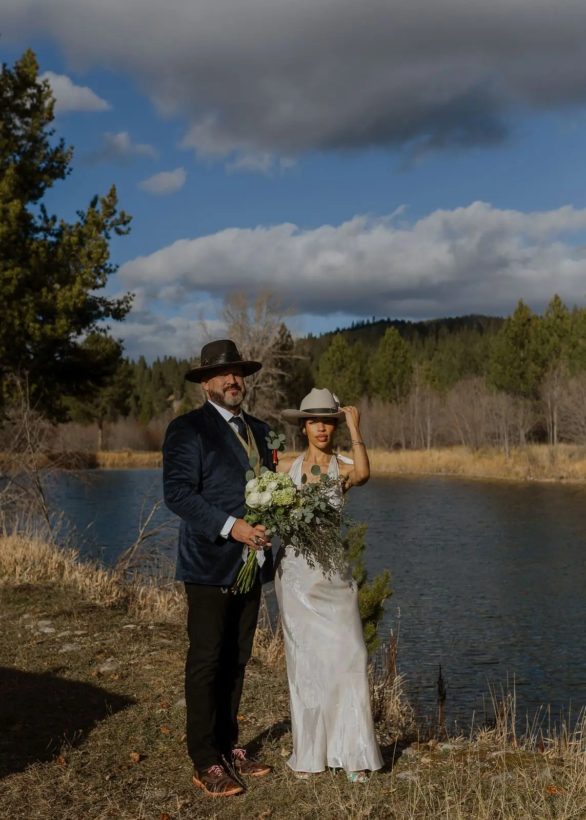 A bride and groom beside the trout pond at Alta Ranch