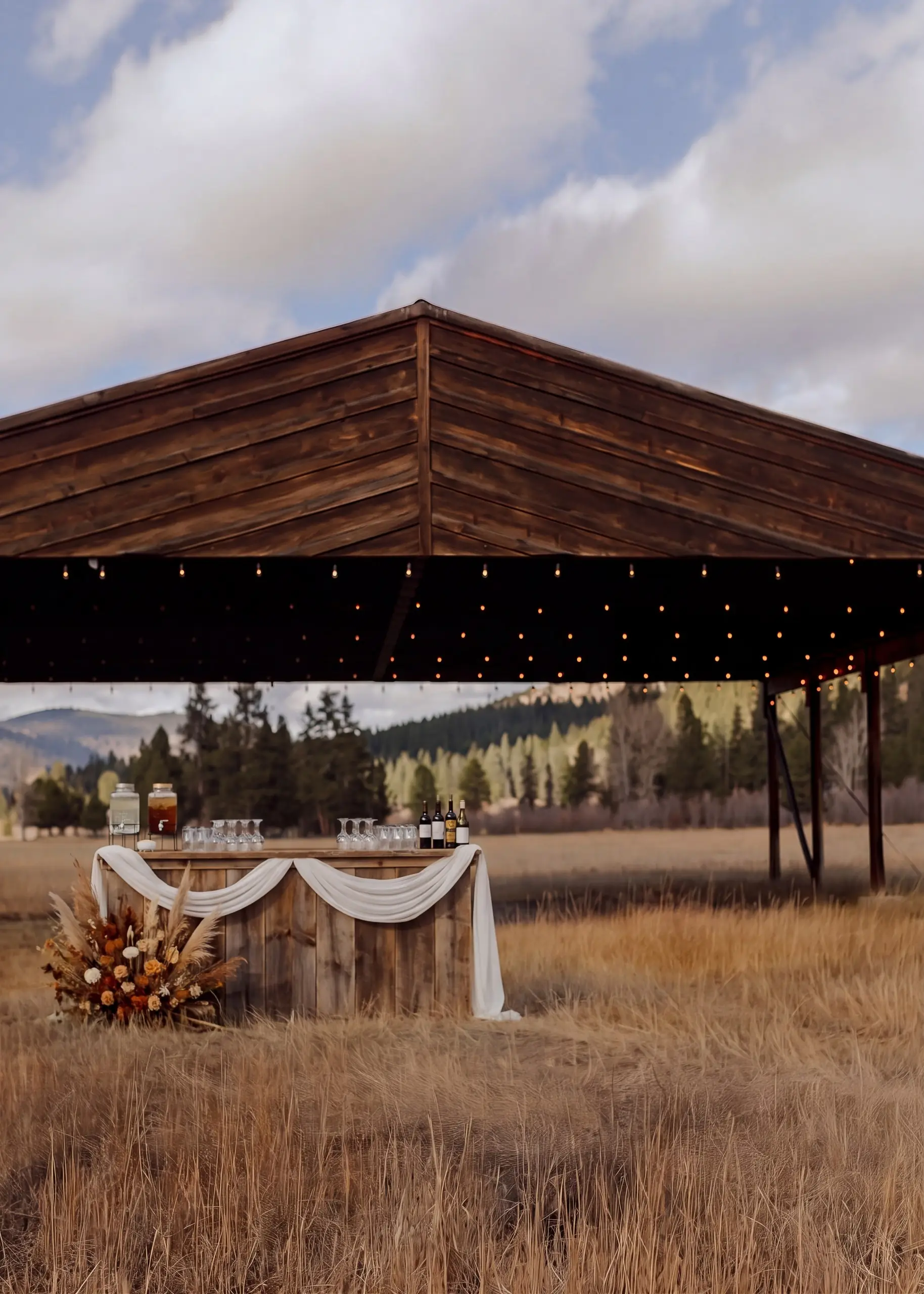 Styling idea: a draped bar with florals at the edge of the hangar