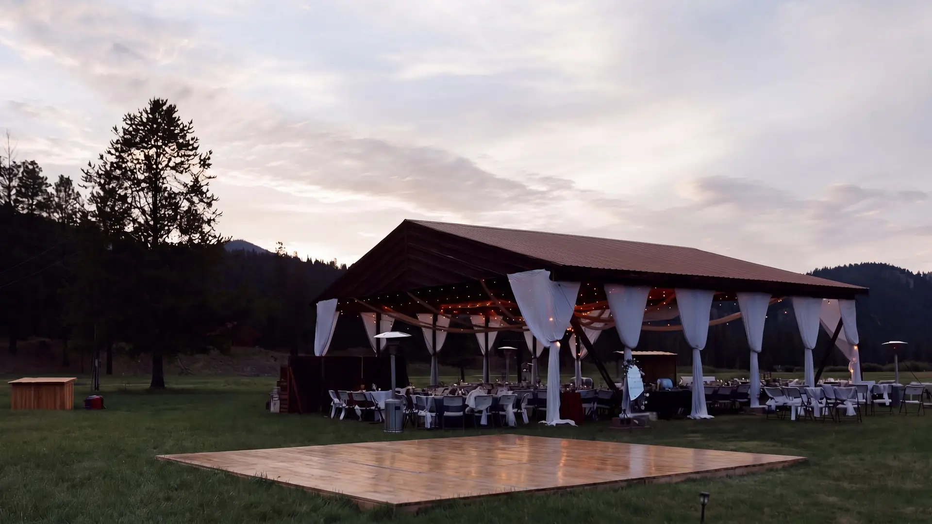 Styling idea: a dance floor on the grass in front of the hangar at dusk