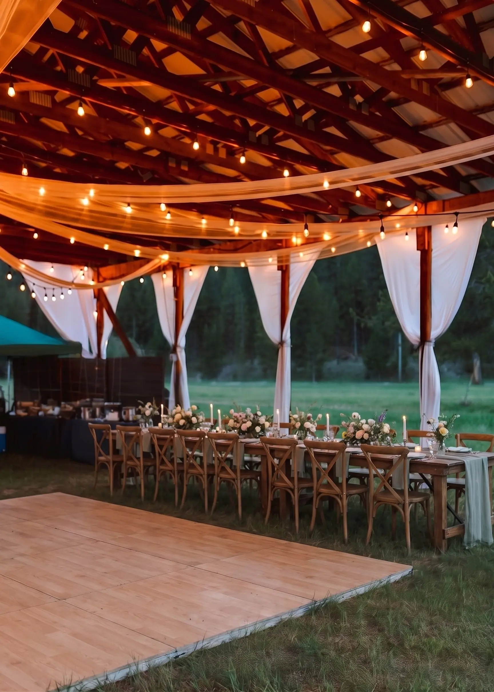Styling idea: a dance floor laid out beside long tables under the hangar string lights and drapes